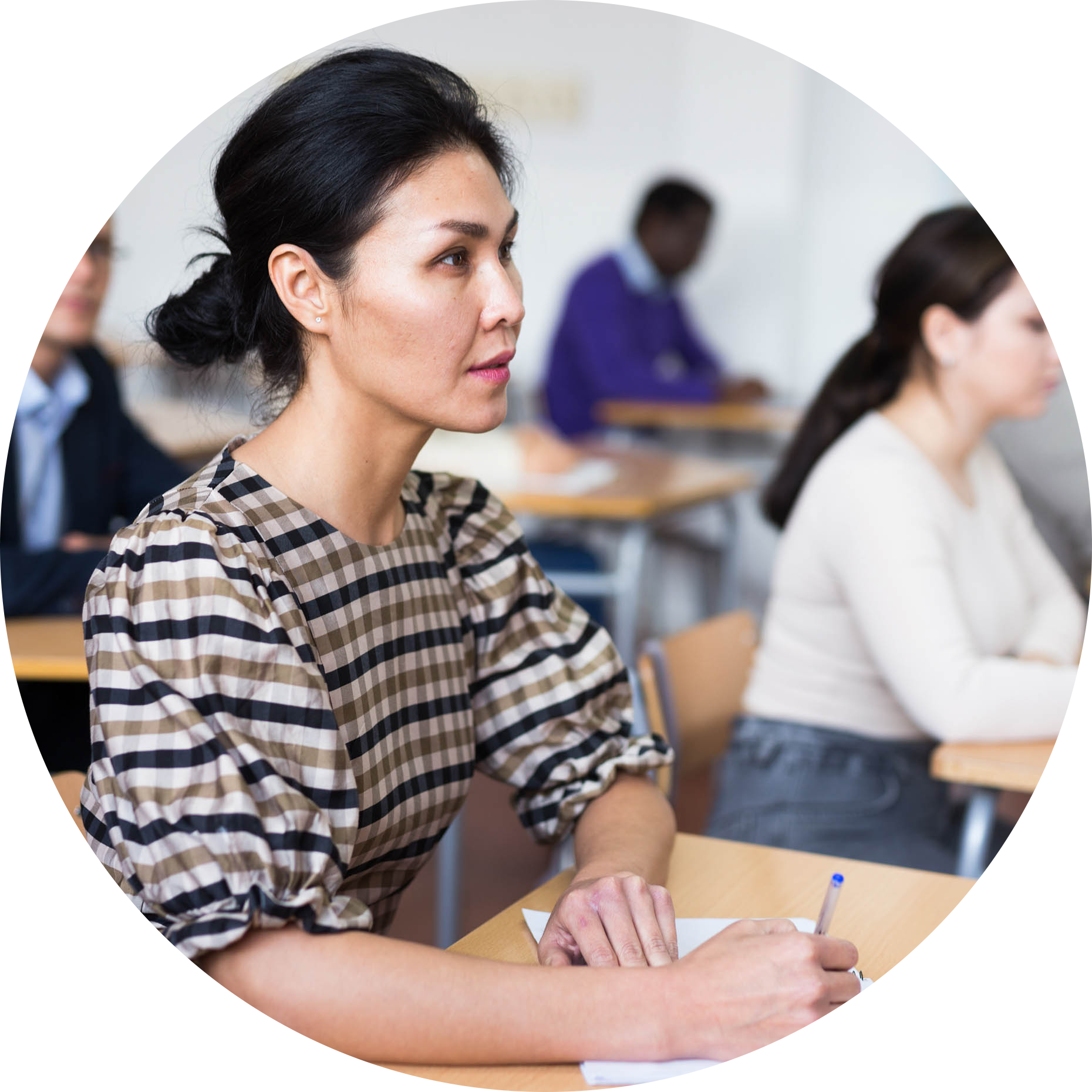 AdultLearners-011-Asian-woman-listening-to-lecture-in-classroom-with-group-circle.png